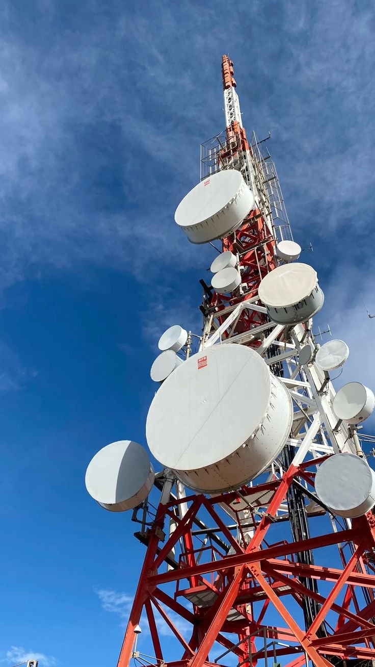Students studying telecommunication engineering foundations in a professional classroom